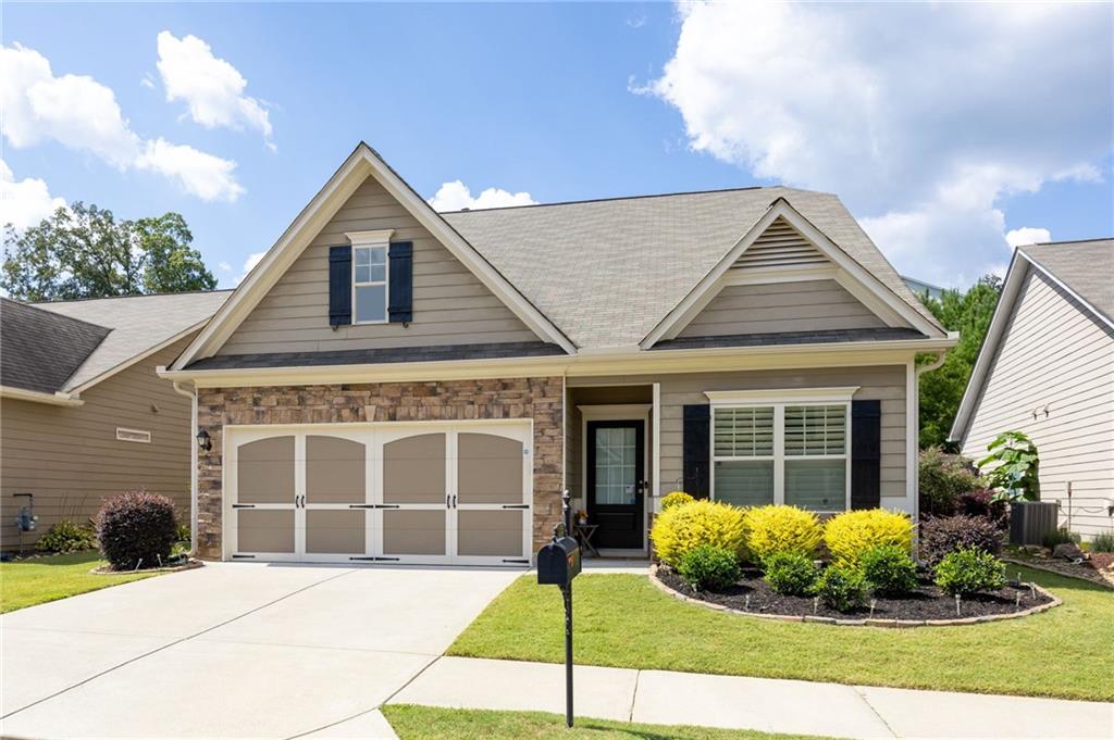 This beautiful 3-bedroom, 2,312 sq ft home has a spacious layout with a main-level office, beautiful kitchen, family room with fireplace, and the primary on the main. Enter into the well lit foyer to find loads of natural light, warm toned modern flooring, and neutral paint throughout. Just off the entry is a home office with great windows overlooking the front yard. Continue on into the main living quarters where you will find your open concept family room, kitchen, and dining space. The family room features a cozy fireplace and direct access to the back patio. The kitchen has top of the line finishes including white cabinets, stainless steel appliances, stone countertops, a center island with bar seating, and a pantry. The adjoined dining room offers a great space to entertain with a view into the family room. The primary bedroom is oversized with space for a seating area, a modern tray ceiling, an en suite bath complete with an large shower and double vanity. Also located on the main are your laundry room and a half bath. Head upstairs where you will find a finished loft space offering you flexibility for an additional seating area, game room, play area, or study. This is a great bonus space to fit to your needs. The two additional bedrooms are well sized, offer walk in closets, and share the second full bath with shower-tub combo. You will fall in love with the enclosed back patio complete with ceiling fan and a stunning view of the landscaped backyard. The fenced backyard is a great size to enjoy, yet easy to maintain. This home offers loads of curb appeal with a flat driveway, covered front entry, and beautifully manicured landscaping. Centrally located in the heart of Canton with close proximity to Hickory Log Reservoir, shopping, dining, and I-575. You will enjoy easy access to local attractions such as Downtown Canton, The Mill at Etowah, and other community parks and events. This is a fantastic home tucked away in the highly sought after community of Towne Mill offering amenities such as swim, tennis, a park, and so much more!
