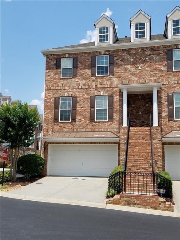 End Unit with Upgrades in Top-Rated School District! This beautifully maintained home features granite countertops, tiled backsplash, and hardwood floors throughout the main level. Enjoy the convenience of walking to restaurants, shopping, and banks, with Emory Johns Creek just minutes away. Located in a gated swim and tennis community. Recent updates include brand new carpet, fresh interior paint throughout, and a new dishwasher. This home has been meticulously cared for. No pets allowed.