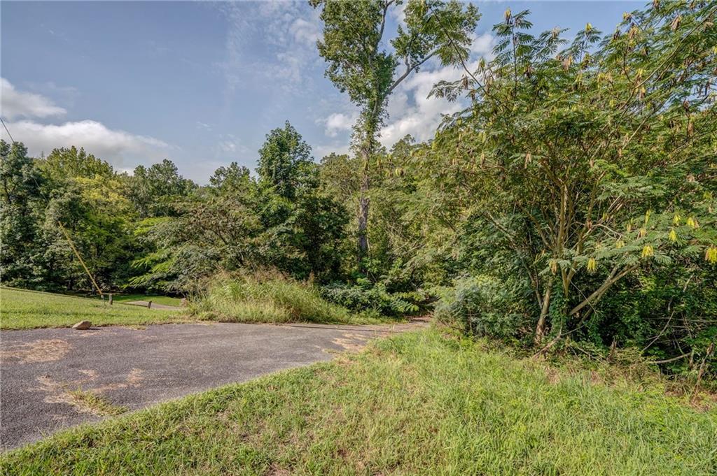 Peaceful and private, this expansive 59.44-acre estate spans four wooded parcels, offering a rare chance to shape a one-of-a-kind retreat in a natural setting. The property invites endless possibilities, from crafting a thoughtfully designed residence to creating recreational spaces that embrace the outdoors. Towering trees, open clearings, and a meandering creek enhance the sense of tranquility, providing a backdrop that feels both secluded and inspiring. With ample room to imagine gardens, walking trails, or wide stretches of open land, the opportunities are as vast as the acreage itself. Despite its quiet atmosphere, the location maintains convenient access to shopping, dining, and daily needs, making it a unique blend of seclusion and practicality. A rare offering for those seeking space, beauty, and vision.