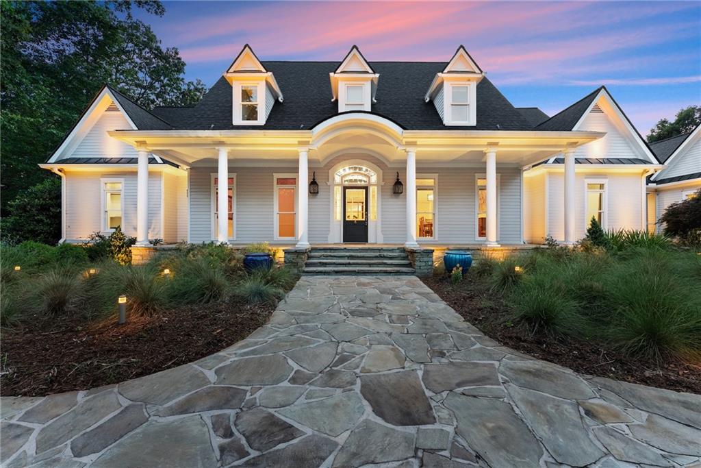 Perched on over 14 stunning acres, this breathtaking estate blends timeless elegance with unmatched tranquility in the heart of Dahlonega. Welcome to 77 Old River Road—a refined mountain retreat offering stunning views, total privacy, and a lifestyle of peace and sophistication.
As you arrive, the stately driveway winds through professionally designed landscaping and leads to a grand Southern-style residence that captures the essence of North Georgia mountain living. Inside, the main level unfolds with warmth and elegance—featuring an open-concept layout, hardwood floors, soaring ceilings, and designer lighting.
The expansive primary wing on the main floor includes a private fireplace, a newly updated spa-like bathroom, and access to a private deck with postcard-worthy views of the backyard oasis. A secondary ensuite bedroom, formal library/office, welcoming living room with fireplace, and gourmet kitchen with a breakfast nook and keeping room provide space for both relaxing and entertaining. Step out to the screened porch or enjoy the tranquil koi pond below—this is serenity redefined.
Upstairs, discover a second luxurious primary suite, with custom cabinetry, additional guest bedrooms with flexible space for hobbies or work, and a cozy bonus room that could function as another office, or movie theater.
Downstairs, the fully finished terrace level is an entertainer’s dream, second family room, bonus space perfect for a theater, gym, or game room, and walk-out access to the outdoors.
Outdoors, custom-crafted railings line peaceful walking paths, and multiple porches and decks invite gatherings under the stars. The estate includes ample parking with the three car garage and no HOA restrictions—offering freedom and comfort, just minutes from Downtown Dahlonega.
Recently renovated with high-end finishes and featuring dual primary suites, this rare gem is perfect for those seeking luxury, privacy, and the magic of mountain living.
