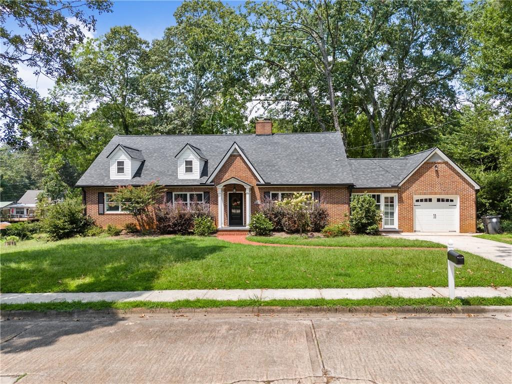 All brick home in the city. Over $100,000 in renovations and new electrical, hardwood floors, built in 1948 but totally renovated since then, new bathroom added in past 2 years, finished daylight basement with kitchen and second driveway (perfect for in-laws), over $40,000 in new double pane windows, mudroom entry with built in cabinets and new windows and door (perfect for pets and kids), level landscaped lot, second driveway that can accommodate a boat, RV, or several cars, wooden swing/play set in backyard, raised garden bed, deck off kitchen with pellet grill, EV charger in garage. Walk to parks, schools, hospital, churches, and downtown Gainesville square. Rent kayaks at the boat dock at the park on the lake, which you can walk to. Thoughtful renovations preserved details such as crystal and brass doorknobs, beautiful tile baths, and brick interior walls in basement, as well as a brick fireplace with new gas logs. If you love the city life, but want a big yard, and plenty of parking, this is the one for you!