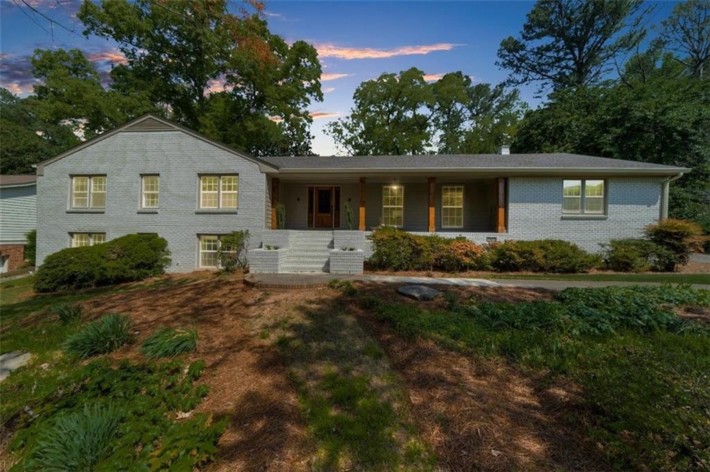 BRING ALL OFFERS! Welcome to your dream home! This beautifully renovated, all-brick ranch perfectly blends timeless charm with modern luxury. Nestled on a large, tree-lined lot, this home greets you with fresh landscaping and a welcoming front porch with warm wood accents. Step inside to a stunning open-concept layout flooded with natural light and thoughtfully designed for effortless living and entertaining. The spacious living room features a cozy fireplace, built-in shelving, and direct access to a serene screened porch - ideal for morning coffee or evening relaxation. The gourmet kitchen is a true showstopper with sleek quartz countertops, stainless steel appliances, an oversized island, and custom cabinetry, all open to a large dining space and stylish living area. Additional highlights include light oak hardwood floors throughout, updated lighting, designer finishes, and a flexible floorplan perfect for any lifestyle. This is more than just a home - it’s a fresh start, a peaceful retreat, and an entertainer’s dream all in one. Conveniently located near local dining, parks, and top-rated schools. Don't miss your chance to own this move-in-ready gem! All furniture is available for sale or the home can be purchased fully furnished. Seller is giving a $15,000 concession for new fence to be put in the back yard to your buyers preference.