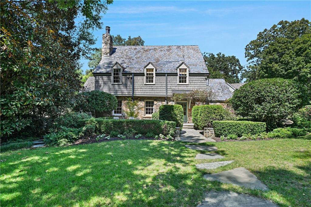 Welcome to one of the most iconic homes and curb appeal in Buckhead’s beloved Garden Hills, located on Pine Tree Drive. This home pairs historic character with modern refinement. Set on a beautifully landscaped large fenced, front yard and a private backyard lot, this over 4,700 square feet home, showcases a classic slate roof, inviting cottage curb appeal, and a private backyard oasis complete with a sparkling pool and spa.
Inside, light pours across hardwood floors, creating a warm, elegant ambiance throughout. The home offers several areas with fireplaces for formal dining and entertaining, in addition to four spacious bedrooms and four and a half baths, including a primary suite retreat with heated floors, freestanding soaking tub, and a walk-in shower designed for ultimate relaxation.
The heart of the home is its gourmet kitchen, outfitted with Gaggenau European appliances and two expansive islands. Flowing seamlessly into an additional fireside family room with even private space for a loving pet and, an additional sunroom perfect for a yoga area or office. .
Downstairs, the finished terrace level is a true extension of the lifestyle, featuring a stone-enclosed room perfect for a speakeasy, also a media room, full bathroom with steam shower and kitchenette. This open design invites gatherings that extend effortlessly to the poolside terrace. Lush gardens and multiple seating areas transform every moment into a resort-like experience.
With an attached two-car garage plus additional parking, and a location just one block from the Garden Hills pool and park, walking distance to Atlanta International School, Christ the King and Garden Hills Elementary, this home embodies the best of historic charm, location, curb appeal and modern luxury. 400 Pine Tree Drive NE has been a landmark address and a lifestyle in Garden Hills.