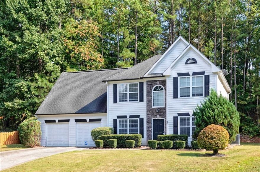 Beautiful, move-in ready home perfectly positioned on a cul-de-sac lot in popular Milford Woods swim/tennis community! New flooring & fresh paint. Grand two-story foyer welcomes you to separate dining & living room. Spacious kitchen featuring granite & eat-in area opens to impressive two-story great room with gas-log fireplace, perfect for gathering. Laundry room on main directly from the garage can double as a mudroom. Oversized primary bedroom offers additional space ideal for a sitting area, office, or nursery. The primary bathroom offers double vanity, separate tub & shower & spacious walk-in closet. Additionally upstairs you'll be delighted with two spacious secondary bedrooms & full bath. Enjoy relaxing on the patio overlooking the private, wooded backyard. Conveniently located to EW Connector/Barrett Parkway/Windy Hill, Silver Comet Trail & Wellstar Cobb.