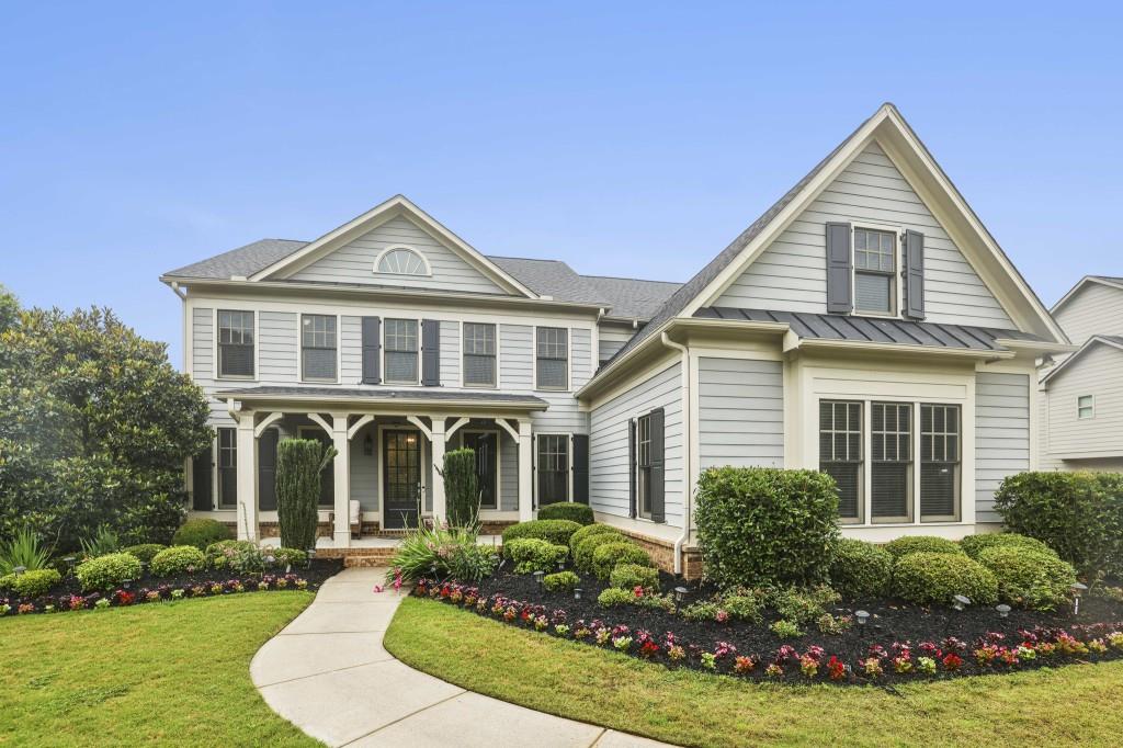 Welcome to this Immaculate and Stylish Modern Farmhouse, perfectly positioned in the Highly Sought-After Williams Point Swim and Tennis Community known for its Top-Ranked Forsyth County Schools, Excellent Restaurants, and the Vibrant Cumming City Center. From the moment you arrive, the Curb Appeal wows with Beautiful Landscaping, Blooming Flowers, Manicured Lawn, and a Spacious Driveway. Grab a cup of coffee and enjoy the Covered Front Porch made for Rocking Chairs and Relaxation. Step inside to a Show-Stopping Entry with Cross-Beamed Ceilings and Gleaming Hardwood Floors that set the tone for the Elegant yet Comfortable Design throughout. Off the foyer, you'll find a Dedicated Office or Study on one side, and a Stunning Formal Dining Room with Crown Molding and Wainscoting on the other Perfect for Holiday Meals or Hosting Dinner Parties. The Heart of the Home is the Fireside Living Room with Soaring Two-Story Ceilings, Walls of Windows bringing in Gorgeous Natural Light, and more Farmhouse details. The space flows effortlessly into the Dreamy Chef's Kitchen featuring White Cabinets, a Massive Granite Island with Extra Storage, Stainless Steel Appliances, and Room for a Breakfast Table. Off the kitchen is a Vaulted Beamed Keeping Room with a Second Fireplace Truly the Spot Everyone Will Gather. Just off the Three-Car Garage, you'll find a Super Functional Mudroom with Built-In Bench, plus a Bedroom and Full Bath on the Main Ideal for Guests or a Second Office. Upstairs, the Primary Suite is a True Retreat with Space for a Sitting Area, an Updated Spa-Like Bathroom with Soaking Tub, Separate Shower, Dual Vanity, and a Huge Walk-In Closet. Three More Spacious Bedrooms, Two Additional Full Baths, and a Convenient Upstairs Laundry Room round out the upper level. And then there's the Basement Seriously, It's Next-Level The Daylight Terrace Level is an Entertainer's Dream Come True. A Huge Game Room awaits, Perfect for a Pool Table, Media Area, or Play Space. The Custom Bar is Straight Out of Your Favorite Sports Lounge with Seating for 8+, a Beverage Fridge, and Sleek Finishes. It Opens to a Cozy Living Room made for Movie Nights and Game Days. There's even a Bonus Bedroom and Half Bath Great for a Guest Room, Home Gym, or Office. Step outside to a Backyard Paradise! The Screened-In Porch off the Kitchen is Ideal for Year-Round Al Fresco Dining. The Fun Continues with a Private Basketball Court and Brand New Batting Cage this is the Backyard Your Friends Won't Stop Talking About! All this in a Beautifully Maintained, Move-In-Ready Home Convenient to GA 400, Shopping, Restaurants, and Outdoor Adventures like Big Creek Greenway, Sawnee Mountain, and Fowler Park. This isn't just a house it's the Total Package. You'll Never Want to Leave!
