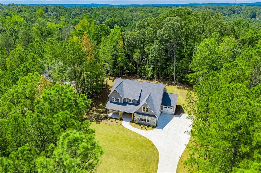 ** SUMMER BLOWOUT- Up to $20,000 in Buyer Closing Concessions w/ Acceptable Offer ** Style meets comfort in this 2-story Modern Farmhouse beautifully situated on a 3 acre lot! From the inviting covered front porch you'll step in to the foyer that looks in to an open floor plan. This space holds the great room, kitchen and dining area. The great room features a delightful electric fireplace, an 11' ceiling and access to the covered rear porch. The amazing kitchen features a huge island with breakfast bar, ample cabinets, walk-in pantry, and opens to the dining area. Conveniently located on the lower level is your relaxing master suite. The spacious master bedroom features a coffered ceiling, a huge walk-in closet and the bathroom with dual vanities, private toilet area and separate soaking tub and tile shower complete the suite. On the upper level you'll find three additional bedrooms, two of which have walk-in closets. A Jack and Jill bathroom separates two of the bedrooms and another bathroom is just a few short steps away from the third bedroom. There is also an expansive loft and bonus room located on this level, perfect for movie/game night or curling up with a good book. Other key features of this already exceptional home include an office/den with windows on two sides and access to the rear porch. The laundry/mud room on the lower level is accessible from both the home and the garage, allowing you to keep sports equipment, jackets and shoes out of sight. The 252 sq ft covered front porch plus the 308 sq ft covered rear porch give you plenty of outdoor living space. Don't let this amazing new home pass you by, schedule your viewing today!