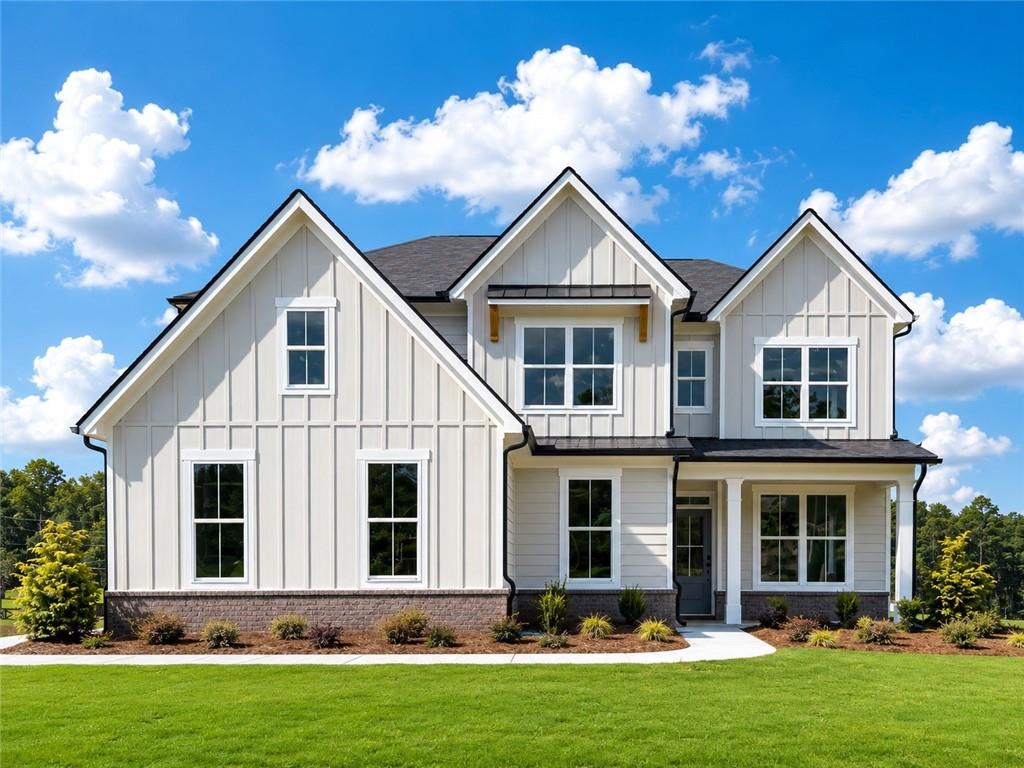 Contemporary farmhouse exterior with board and batten siding and a dark shingle roof