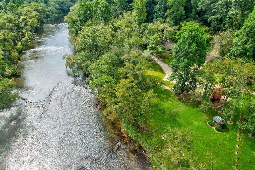 This is a rare and extremely limited opportunity-only one lot remains available in the highly sought-after Gated River Ridge on the Toccoa community! This exceptional 4.04-acre parcel offers the perfect combination of privacy, natural beauty, and convenience, just 4 miles from Downtown Blue Ridge and five minutes from Old Toccoa Golf Course. Located near the main gate, it provides quick access and a peaceful and private setting. Imagine building your dream home on this expansive, gently rolling landscape with mature trees, a natural spring, and a quiet stream that begins right on the property. The lot is a 'cuddle sac'-tucked away in a serene area with complete privacy and no through traffic. It flows seamlessly to the well-maintained community river access, offering excellent opportunities for fishing, tubing, kayaking, or simply relaxing by the water. The subdivision has been approved and is moving forward with paving, with utilities already in place, making it easy to develop your perfect mountain retreat with modern comforts. Backing directly to Old Toccoa Golf Course, this location boasts stunning views and easy access to the course. The community amenities include a pavilion, picnic areas, and a charming gazebo-perfect spots for outdoor gatherings or quiet reflection. Whether you're seeking a primary residence, vacation home, or short-term rental investment, this property truly has it all, offering proximity to shopping, dining, outdoor adventures, and the tranquil mountain scenery of Blue Ridge. Properties like this are extremely limited-this is your last chance to own in this exclusive, amenity-rich neighborhood. With incredible privacy, natural beauty, and a prime location, it's a rare opportunity that won't last long. Act quickly-reach out today and make this extraordinary property yours before it's gone! And Blue Ridge itself offers a vibrant, charming small town atmosphere with fine dining, unique shops, outdoor attractions, and endless adventures.