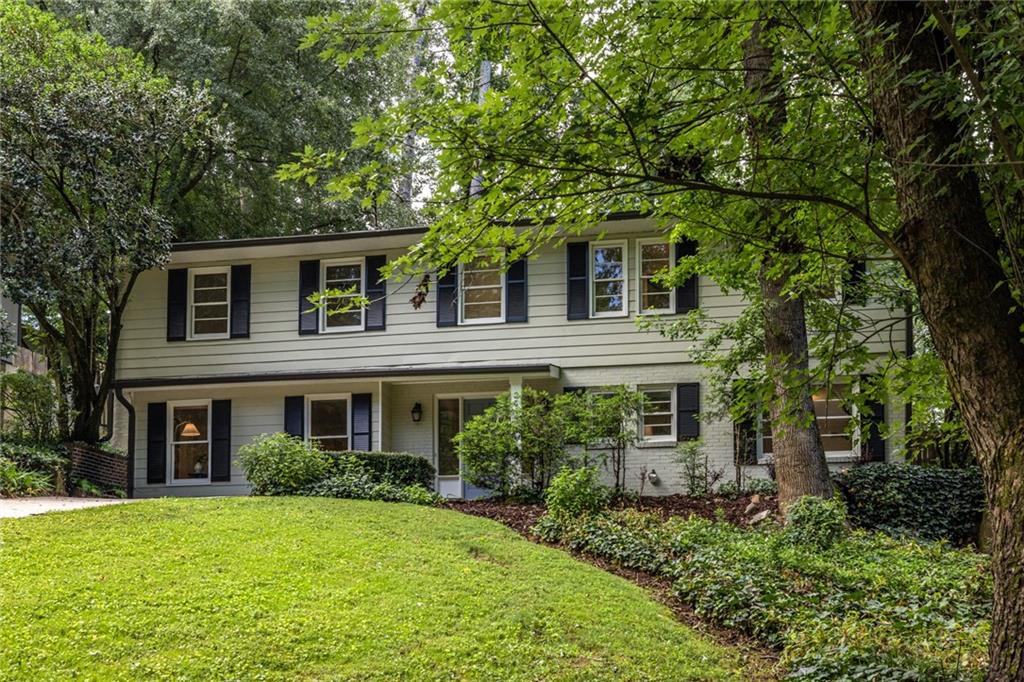 Come see this classic 4BR/2.5BA home that works well for modern comfort and livability. Located on a quiet cul-de-sac in a tree-filled neighborhood just minutes from Toco Hills and the new Lulah Hills mixed-use development. This home offers a peaceful, comfortable living environment with plenty of space inside and out.
=== MAIN LIVING SPACES ===
Step inside through the welcoming front entrance. The large living room features huge windows, beautiful wood floors, and an abundance of natural light. Hardwood and tile flooring throughout the home makes it clean and easy to maintain.
The kitchen has new butcher block countertops, new sink, updated fixtures, generous cabinet space, and two windows that fill the room with light. It opens directly to the dining area, which includes a fresh light fixture and a second sitting area that adds flexibility for entertaining or relaxing.
Just off this space, large sliding doors lead to a private patio—perfect for outdoor dining, lounging, or entertaining. The layout creates great flow between indoor and outdoor living areas.
=== BEDROOMS + BATHROOMS ===
All bedrooms and full baths are located upstairs for convenience and functionality.
The primary bedroom is set apart from the others, providing extra privacy and space. It features hardwood floors, plenty of closet space, and an en-suite bath with updated fixtures, a new vanity, and large windows that bring in natural light and give the space a mid-century modern feel.
An additional room connected to the primary suite can serve as a nursery, office, workout space, craft room, or a fourth bedroom.
The second and third bedrooms are connected by a recently renovated Jack-and-Jill bathroom. All bedrooms have good natural light and useful closet space.
A large upper-level deck overlooks the huge fenced backyard, adding another place to enjoy the outdoors.
=== OUTDOOR + PARKING FEATURES ===
The backyard is fully fenced, spacious, and great for playing, relaxing, or hosting. A shed provides extra storage for yard tools or toys.
There are two driveways—one that leads to the front of the house on the main level, and one that leads to the back of the house on the upper level. This setup is super convenient and offers off-street parking for 5 to 6 cars. Additional street parking is also available for guests.
The front yard and cul-de-sac add even more usable outdoor space for gathering or play.
This thoughtfully updated home offers charm, comfort, and flexibility in a location that continues to grow in convenience and value.