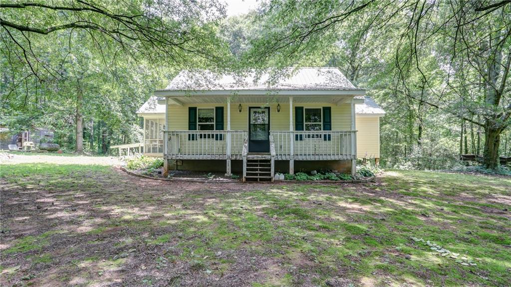 NOW LISTED ....A slice of paradise with this simple yet inviting cabin nestled on 4+/- private acres just minutes from the scenic North Georgia Mountains. Surrounded by nature, this property offers peace, privacy, and loads of room to grow. The cozy 1 Bed/1 Bath, with extra room that could be a 2nd bedroom, home provides a solid foundation with rustic charm and loads of potential—whether you’re looking to renovate, expand, or enjoy as-is. The open floor plan, screened in porch and metal roofing are all added features to this adorable cabin in the woods. With acres of level usable land, the possibilities are endless: plant a garden, start a small hobby farm, build additional cabins or guest quarters, create a workshop, or simply relax and take in the beauty of your own private outdoor space. And if it's added income you're looking for...this property offers rental possibilities or renovation for resale, making this a prime piece of real estate. The location couldn't be better....offering North Georgia's abundance of hidden gems, from scenic hiking trails and cascading waterfalls to local wineries and charming mountain towns, all within a short drive away. Conveniently located near Crystal Falls Golf & Country Club, Big Canoe, and the stunning Gibbs Gardens, you can't go wrong! Only 30 minutes to GA 400, this location offers the perfect balance of seclusion and accessibility. Whether you're dreaming of a quiet mountain retreat or eyeing income potential such as Airbnb, this property offers country living at its best—with privacy, charm, and endless opportunity, this one isn't going to last long! ****NOTE: There is NO HVAC or central air in the home.*****