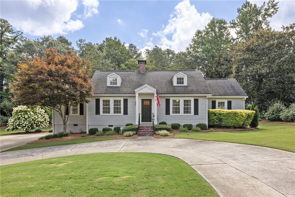 If you’ve been dreaming of life in East Cobb’s most coveted school trifecta—Soap Creek, Dickerson, and Walton, then grab your sweet tea and get ready, because this one checks every box and then some. Sitting pretty on a completely flat .65-acre corner lot, this 3-bedroom, 2-bath Cape Cod-style bungalow blends cozy charm with big-time potential. From the circular driveway (with parking for all your people) to the lush, grassy yard that’s ready for playdates, pups, or even a future pool, this home offers room to breathe and space to grow. Inside, you’ll find gleaming hardwood floors, a crisp, updated kitchen, and two beautifully renovated bathrooms. All three bedrooms, including the primary all on the main level, making this layout ideal for a young family, empty nesters, or anyone looking for easy, one-level living. The cozy family room is perfect for curling up with a good book by the fire or watching the big game, while a sitting room or perfect work from home space with French doors that spill out to the oversized deck is just begging for your next backyard BBQ or morning coffee moment. Need a little more room in the future? You’ve got permanent stairs to the attic and space to expand if you want to add on or better yet... you're sitting on a premiere building lot. You’re surrounded by multi-million-dollar homes, so whether you’re buying for yourself or scooping up a smart investment, this home is holding strong in good company. Updated, loved, and located in one of the best pockets of East Cobb, The Dickerson House is more than just a smart move, it’s the kind of place that feels like home the minute you pull in the drive. Picket fence perfect, no pretense, just pure potential and Southern comfort. Come see it before it’s gone.