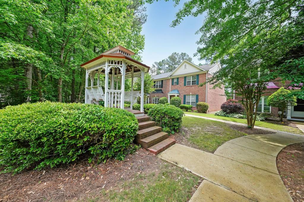 Beautiful 3 Bedroom/2.5 Bath Brick Townhome In The Heart Of Kennesaw. Located Near So Many Restaurants, Parks, Schools, And Shopping. Quiet Community. This Unit Features An Open Family Room Kitchen, With Large Eat In Dining Area. Kitchen Boasts Tile Backsplash. Well-Maintained, NEW ROOF June '24! Clean And Ready For Immediate Occupancy! Upstairs Owner Suite Has Private Bath With Large Soaking Tub /Shower. Tree Lined Street For Privacy HOA fees include ground maintence and water. Parking Is In The Rear Of The Home And Has Room For 2 Cars. Outside Storage Room. Additional Features Include: Newer Luxury Vinyl Flooring And Newer HVAC.
