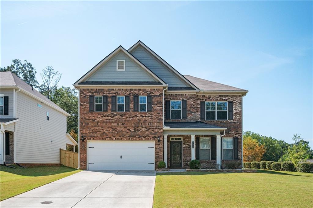 Located conveniently between Downtown Acworth and Woodstock, this charming four bedroom and four bath home is just six years old! From the moment you walk in the door, you'll notice the spacious kitchen and living area with daylight pouring in. This property is designed to easily entertain, with an open concept floor plan on the main level, as well as a guest bedroom and full bath! This lovely home boasts gorgeous stained wood kitchen cabinets with granite counters, and a large kitchen island. Cozy up next to your gas fireplace in the living room or enjoy morning coffee on your private, covered patio with fans and gas grill connection. The garage even has it's own countertop with sink and vent hood, perfect for when larger gatherings need a place to spill over into or can be used as a work space. The dining room is spacious and has chair molding and wainscoting. Once upstairs, you'll appreciate the idea of never having to carry laundry up or down stairs ever again! The laundry room is huge and has a large closet for all of your storage needs! The primary bedroom is spacious and inviting, and the primary bath has dual vanities, a separate tub and shower, and a huge walk-in closet. The spacious secondary bedrooms upstairs each have their own private en-suite bathroom. So many things to do close by! Patriots Park, Hobgood Park, Eagle Drive shopping, Downtown Woodstock, Downtown Acworth, Lake Allatoona, Redtop Mountain State Park, and much more. Fantastic schools - Boston Elementary, E.T. Booth MS, and Etowah HS. Don't miss the floor plans at the end of photos! Victory Preserve offers a gazebo and dog park and has lighted streets and sidewalks. Some photos are virtually staged.