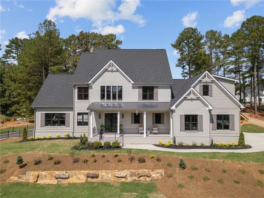 Welcome to this remarkable new residence, perfectly positioned on a sprawling 1.2-acre lot in a prime Milton location. This exquisite home exudes sophistication and modern luxury, seamlessly blending elegance with comfort. Upon entering, you are greeted by an inviting open floor plan, accentuated by site-finished hardwood floors and custom lighting throughout. The expansive main level features a lavish master suite, complete with a spa-inspired bathroom and generous walk-in closet, as well as an additional guest suite or office, perfect for visitors or a quiet workspace. Designed with entertaining in mind, the home boasts a spacious family room with coffered ceilings, a Thermador-equipped gourmet kitchen featuring custom cabinetry, a large walk-in pantry, and a wet bar with wine fridge. The informal dining area opens to sliding glass doors, leading to a covered patio that offers seamless indoor-outdoor living. The expansive, flat backyard is an entertainer's dream, ideal for gatherings or the future addition of a pool. Throughout the home, a premium speaker system provides the perfect ambiance, whether you’re hosting a lively event or enjoying a quiet evening in. Upstairs, three ensuite bedrooms provide ample space and privacy, while a versatile bonus room with a full bathroom offers flexibility for a media room, gym, or additional guest space. The unfinished basement presents endless possibilities for customization, catering to your unique lifestyle needs. This home is one of only three exclusive residences in this coveted development, offering unparalleled luxury and convenience in the heart of Milton. Don’t miss your opportunity to own a piece of this prestigious enclave.