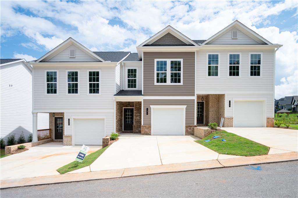 Come to Chimney Oaks and see our Nicole floorplan. Welcome to your dream townhouse — where modern design meets golf course serenity. This 3-bedroom, 2.5-bath home offers 1,296 sq ft of thoughtfully designed living space with soaring 9 ft ceilings upstairs and down, creating an open and airy atmosphere. The heart of the home is the open-concept kitchen and living room, perfect for entertaining. A sleek electric fireplace with a striking tile surround stretching to the ceiling adds a contemporary focal point to the space. The gourmet kitchen boasts stainless steel appliances, gleaming granite countertops, and a generous island for cooking, dining, and gathering. Step outside to your private back patio and enjoy peaceful golf course views — an ideal setting for morning coffee or evening relaxation. With a functional floor plan, stylish finishes, and a prime location on the fairway, this townhouse blends comfort, convenience, and charm. Don’t miss the opportunity to live in a home that offers both modern elegance and scenic tranquility.