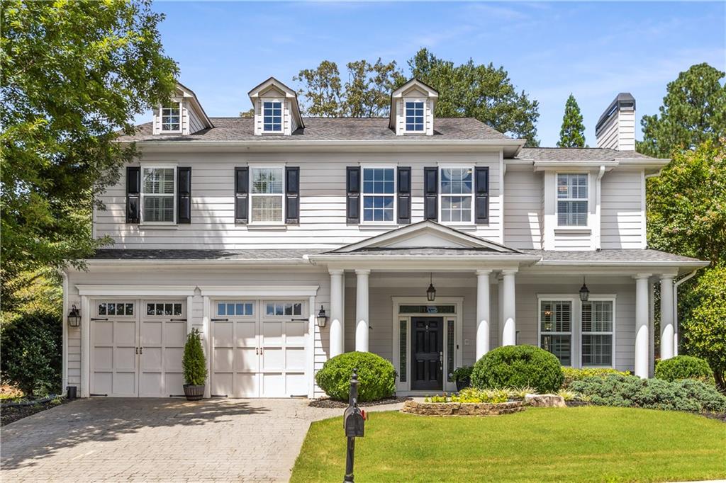This former model home, built by the original Wynchase developer, showcases over 3,700 square feet of living space filled with upgrades and distinctive finishes not found in other homes in the community. Just 2.5 miles from downtown Woodstock, it sits on a premium lot offering both convenience and privacy.
Tucked between two landscaped, unbuildable lots maintained by the HOA, the property enjoys unobstructed views of open green space and the neighborhood’s top swim and tennis amenities.
Inside, a grand staircase sets the tone for the home’s thoughtful design. A fireside office and banquet-sized dining room with butler’s pantry highlight the home’s sophisticated style, while the chef’s kitchen—with custom cabinetry, beadboard details, a granite island, and commercial-grade appliances—opens to the living room and second fireplace for seamless entertaining.
Upstairs, a spacious loft with custom built-ins offers flexibility for a media room, study, or additional sitting area. The primary suite is a private sanctuary, designed with vaulted ceilings, intricate millwork, and a cozy fireplace. Its spa-inspired dressing area and custom walk-in closet elevate everyday living into a true luxury experience. Completing the upper level are three well-appointed secondary bedrooms that provide comfort and functionality for family or guests.
Three inviting outdoor areas—a covered front porch, covered back patio, and private courtyard with pergola—provide perfect spaces for relaxing or entertaining. With plantation shutters on every window and a wealth of custom upgrades throughout, this home is as polished as it is unique. Don’t miss this beauty!