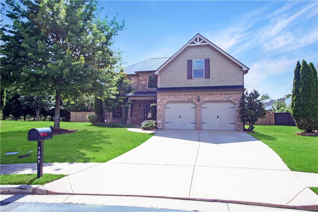Now available for lease! Discover this beautifully updated 4-bedroom, 2.5-bath home tucked into a quiet cul-de-sac in one of Buford’s most desirable communities. Zoned for top-rated schools, this home boasts refined finishes, a fantastic backyard, and unbeatable curb appeal.
Step inside to a soaring 2-story foyer filled with natural light, complemented by brand-new hardwood floors, elegant coffered ceilings, arched entryways, and classic crown molding throughout the main level. The formal living and dining areas provide ideal spaces for entertaining, while the gourmet kitchen offers granite countertops, a center island, stainless steel appliances, and rich maple cabinetry—all overlooking a professionally landscaped backyard.
The kitchen dining area features beautiful views of the garden, and flows seamlessly into a bright, open-concept family room with a custom stone wood-burning fireplace, perfect for cozy gatherings.
Upstairs, the oversized primary suite includes a spacious sitting area, a large walk-in closet, and a spa-like ensuite bathroom with vaulted ceilings, dual vanities, a soaking tub, and a separate walk-in shower. All secondary bedrooms are generously sized with excellent closet space.
Enjoy morning coffee or weekend barbecues on the covered back porch that overlooks the lush, private backyard with privacy fencing—a rare find in the community.