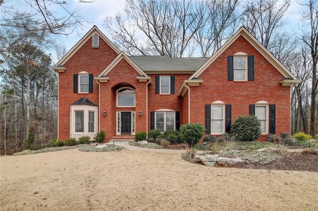 Welcome to 2740 Stonehill Way in Stonegate at Big Creek. This charming home offers the best of suburban living with a tranquil environment and convenient amenities. Located on a peaceful cul-de-sac, this brick-front house features a welcoming ambiance and great curb appeal. Inside, the grand 2-story foyer leads to a dining area with crown molding and chair rail accents, perfect for gatherings. There's also a versatile formal living room or office with elegant French doors. The main level includes a spacious kitchen with stained cabinets, an island, and a bright breakfast area. The kitchen flows into a cozy keeping room with built-in shelving and a fireplace. A large two-story sunroom offers panoramic views of the lush backyard. The grand two-story great room, with its wall of windows, provides a bright and inviting space for relaxation and entertainment. Upstairs, the master suite features a sitting area, trey ceiling, and a luxurious master bath with a separate shower and soaking tub. Three additional bedrooms and a full bath offer plenty of space for family and guests. The daylight terrace level is perfect for an in-law suite or entertaining, with a second kitchen, craft room, bedroom, full bath, family room with a coffered ceiling and fireplace, and access to the patio overlooking the wooded retreat. Ideal for a growing family, this home includes swim and tennis facilities and is close to trails, lakes, shopping, and restaurants. The owner is open to a 6-month short-term lease.