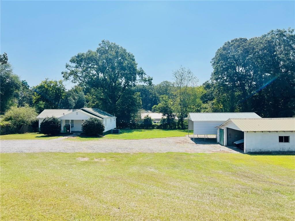 Great Commercial Opportunity! Hwy 411 frontage with easy access to Highway 20, Highway 41 and I75. Property has an older house that could be used as an office with a large lot for storage or a new construction site with ample space for your new business venture. Growing area of Bartow County.