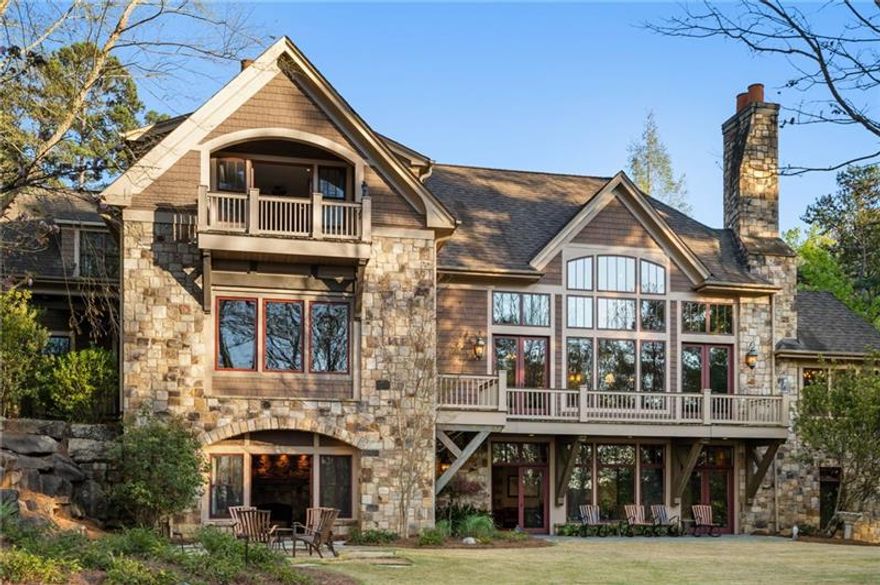 Nestled on an expansive +/-7.09-acre estate in the prestigious Reynolds Lake Oconee community, this one-of-a-kind waterfront sanctuary offers unmatched elegance and breathtaking views. Boasting over 1,000 feet of shoreline, including a white sand beach, two serene coves, and vistas stretching across Lake Oconee to Great Waters, this property is the epitome of luxury lakefront living. This magnificent 13,500 sq. ft. main home, paired with a charming pool house located on a point between the coves, maximizing privacy and panoramic views. The property’s outdoor spaces include a 50 x 25 infinity pool and 1500 square foot pool house, lookout points perfect for watching unforgettable sunsets, fire pits for cozy evenings, and a max dock ideal for boating and water sports. A stone and lighted entrance welcomes you to the tree-lined driveway, leading to the understated grandeur of this architectural masterpiece. Designed by Beck Architecture and built by Taylor Custom Homes, the main house showcases impeccable craftsmanship with soaring hand-hewn beams, a floor-to-ceiling stone fireplace, and scraped hickory floors. A golf membership is available for residents to enjoy world-class amenities, including seven championship golf courses, marinas, tennis courts, pickle ball courts, work out facilities and fine dining. Whether it’s boating on the lake, enjoying the vibrant social scene, or relaxing in this private oasis, every moment is an invitation to embrace the beauty of Lake Oconee living. For the discerning buyer, this estate is more than a home, it’s an experience. Every detail has been meticulously crafted to combine luxury, comfort, and strategically designed entertainment spaces, perfect for hosting family gatherings, intimate dinners, or grand celebrations.  Don’t miss your chance to own this exclusive waterfront estate—where luxury and lifestyle converge in the heart of Reynolds Lake Oconee. Schedule your private tour today!