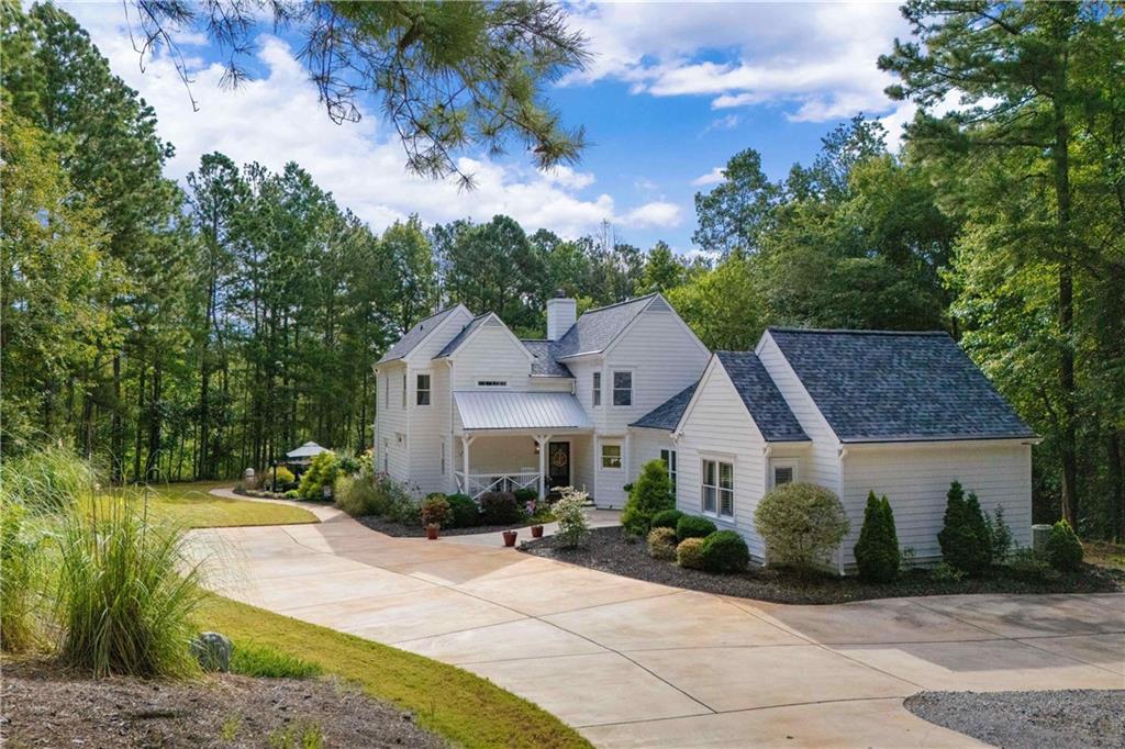 Welcome to your dream country escape! This stunning 5-bedroom, 3.5-bath farmhouse-style home offers the perfect blend of modern luxury and timeless charm. Situated on almost 6 secluded acres, this home at over 3,000 square feet is designed for both comfort and exceptional entertaining. Step inside to find a spacious open floor plan with gorgeous hardwood floors, abundant natural light, and thoughtful finishes throughout. At the heart of the home is the gourmet kitchen featuring stainless steel appliances including double wall oven, quartz countertops, a large center island, and a walk-in pantry - perfect for everyday meals or hosting gatherings. The main-level primary suite is a true retreat with a spa-inspired en-suite bath, views of the beautiful landscaping and private access to the patio. Also on the main level, you'll find a private guest bedroom and full bath, ideal for visitors or multigenerational living. Upstairs are three additional bedrooms and an additional full bath, perfect for family, or a home office setup. Outside, enjoy your own private oasis with a large wrap around porch, an oversized in-ground pool and plenty of space for outdoor dining, lounging, or entertaining. Whether it's summer pool parties or quiet evenings under the stars, this property was made for making memories. Private and peaceful, this property combines the best of country living with modern amenities. Schedule a private tour to see what this amazing home as to offer!