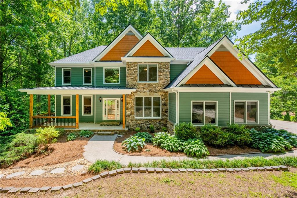 Located in the charming community of Dawsonville, this FULLY RENOVATED, two-story home on a 1.3-acre lot, provides a private setting and offers a perfect blend of modern luxury and serene, North Georgia living. The main floor features an OPEN-CONCEPT layout with GLEAMING HARDWOOD floors, creating a seamless flow from the welcoming foyer to the heart of the home. The family room is a showpiece, with its SOARING VAULTED CEILINGS that create a sense of expansive space and drama, and LARGE WINDOWS that flood the room with natural light. The GOURMET KITCHEN is a chef's dream, boasting high-end stainless-steel appliances, custom cabinetry, and a large peninsula perfect for entertaining. Upstairs, the primary suite offers a true retreat with a brand new, gorgeous DOUBLE-SIZED SHOWER providing a luxurious bathing experience. His and her vanities offer ample space and convenience, complementing the serene ambiance of this private sanctuary. The FINISHED BASEMENT provides additional versatile living space, ideal for a media room, home gym, or guest suite, complete with a full bathroom. With high-end finishes and thoughtful details throughout, this home is designed for a sophisticated and comfortable lifestyle.