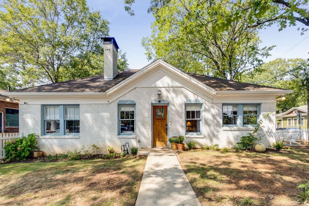 Welcome to this charming 3-bedroom, 2-bathroom bungalow, perfectly situated just a short stroll from downtown Decatur. This delightful home features classic 4-sided brick construction and is enveloped by a white picket fence, enhancing its inviting curb appeal. Step inside to discover a bright and airy interior, where natural light floods every room, highlighting the home's elegant details. The cozy living room boasts a beautiful fireplace and a vaulted ceiling, creating a warm and welcoming atmosphere. The layout is both functional and stylish, with a seamless flow between the living spaces. Upstairs, you'll find a versatile multi-use space that comes with its own full bathroom, offering endless possibilities for a home office, guest suite, or playroom. The property is equipped with all-new systems and a fully encapsulated crawl space, ensuring modern comfort and peace of mind. Enjoy the outdoors in the spacious backyard, complete with a new fence for added privacy and security. With three designated parking spaces, convenience is never a concern. This home beautifully combines classic charm with modern updates, all within easy reach of downtown Decatur's vibrant dining, shopping, and entertainment options. Don't miss the opportunity to make this lovely bungalow your own!