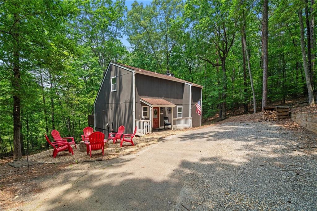 North Georgia Mountain Retreat 2BR + Loft. Welcome to 33 Angelican Way-a beautifully updated cabin tucked into the peaceful hills of North Georgia wine country. Whether you're looking for a personal escape, an STR investment, or a cozy full-time residence, this one checks all the boxes. Inside, you'll find a bright, open layout with vaulted ceilings, hardwood floors, and tasteful finishes throughout. The remodeled kitchen features white shaker cabinets, quartz countertops, a stylish tile backsplash, and stainless steel appliances. The main level offers a spacious bedroom and full bath, while upstairs includes a second bedroom, open loft, and a charming overlook into the living space below. Outside, relax around the firepit, sip wine on the deck, or just enjoy the peace of your private wooded lot with seasonal mountain views. Located in Dahlonega (Cleveland address reflects Lumpkin Co. post office), just minutes from Helen, Blairsville, award-winning vineyards, hiking trails, and waterfalls-this is mountain living at its finest. Bonus: The neighboring cabin at 102 Angelican Way is also available-an ideal opportunity for a dual rental or multi-family setup.