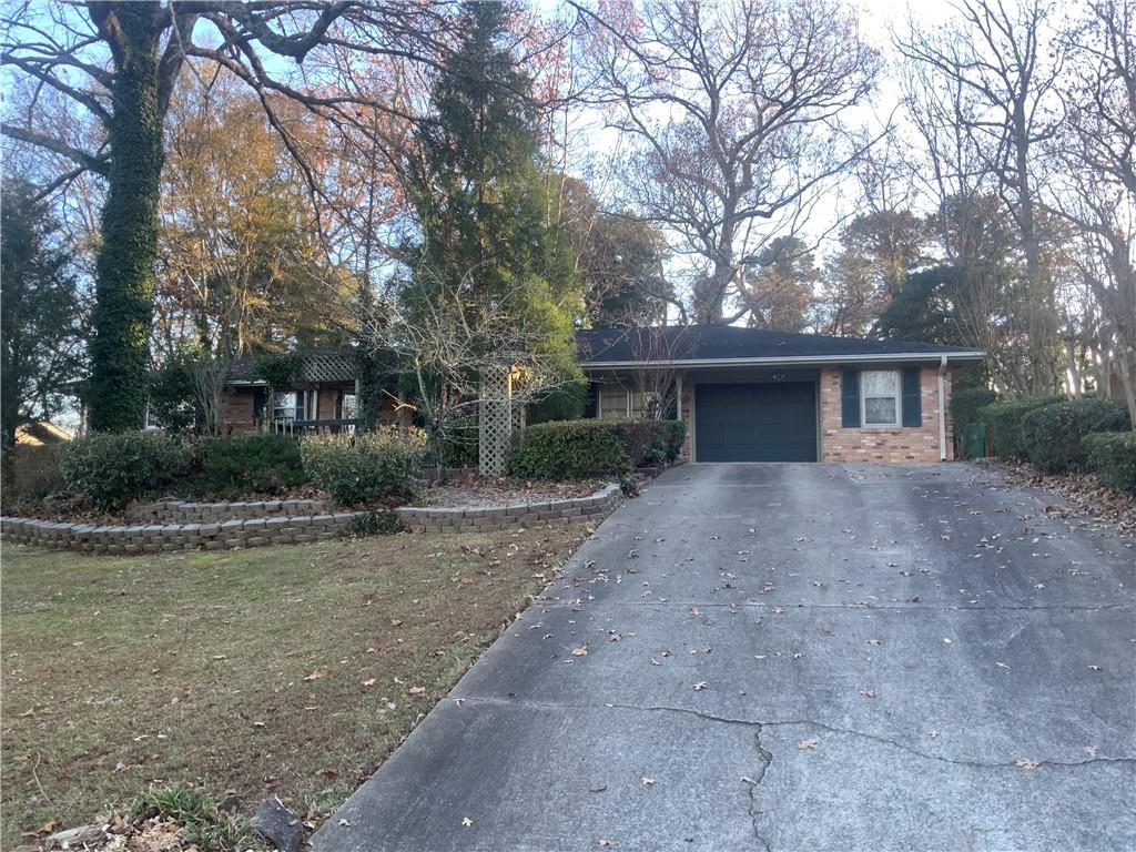 Discover this charming 3-bedroom, 2-bathroom ranch home located in the sought-after Sterling Acres Subdivision in Tucker. This beautifully maintained, 4- sided brick home offers a perfect blend of comfort and convenience, with original hardwood flooring and tile throughout. As you enter, the foyer opens to a formal living and dining room, creating a welcoming and versatile space for gatherings. The kitchen features updated appliances, ample cabinet space, and an in-kitchen dining area with a view of the expansive backyard. Adjacent to the kitchen, the oversized family room offers the perfect space for entertaining, complete with a cozy brick-surrounded fireplace and access to the private backyard. The backyard is truly a retreat, featuring plenty of space for outdoor activities, gardening, and a large outbuilding that can be used for storage or as a workshop. The home’s primary bedroom includes an en suite bathroom, while the additional two bedrooms share a convenient Jack-and-Jill bath. All bedrooms are equipped with organized closets, providing ample storage. A dedicated laundry room with extra storage adds to the home’s functionality, and the attached one-car garage offers additional convenience. Located near downtown Tucker and desirable schools, this home is in an ideal location. With its spacious layout, thoughtful features, and move-in ready condition, this property won’t last long.