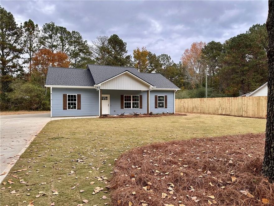 Almost Complete, be in your new home before Christmas! Seller is offering $5000 in incentives to the buyer! 3 Bed 2 Bath stepless ranch situated on .71 acre lot with a private back yard, NO subdivision, NO HOA! Inside, you'll find upgraded luxury vinyl plank flooring—no carpet here! The main living area boasts vaulted ceilings, creating an open and airy atmosphere. The kitchen features beautiful granite countertops,  shaker-style cabinets, and a spacious island, with all kitchen appliances included. The primary bedroom offers a generous walk-in closet and an en-suite bathroom with elegant marble countertops and a walk-in shower. All bedrooms are equipped with ceiling fans for added comfort. Secondary bathroom also offers marble countertops. Step out onto the back patio and take in the view of the level backyard.  You can't beat this location! In less than a 20-minute drive, you can reach I-20 and the towns of Villa Rica, Dallas, Rockmart, Temple, or Buchanan. Interior pictures are from a previous build with similar finishes.