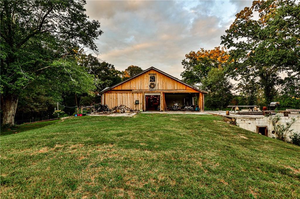 Welcome to a truly unique and versatile property, featuring nearly 23 acres of picturesque land, ideally situated just outside the perimeter of Atlanta. This expansive estate offers a world of possibilities for those seeking beauty, space, and a variety of potential uses. The property boasts multiple pastures perfect for rotational grazing, perfect for farming or equestrian activities. The property’s elevation and open landscapes provide breathtaking views of both sunrise and sunset and seasonal views of Lake Eleanor, making each day feel special. A building that once served as a 66 bed nursing home, now reimagined into the owners' dream home—a transformation worthy of its own HGTV show. Whether you envision creating a serene homestead, a one-of-a-kind gallery space, or a project haven requiring ample room to store, work, and stay—this property can accommodate your dreams. The main living space is approximately 3200 sq ft with 1100 sq ft of open-concept living, dining, kitchen space. The front of the structure known as “The Barn” has approximately 3500 sq ft of open air space. An additional garage space below with approximately 1100 sq ft. A new metal roof was put on the entire structure 7 years ago. A new well, pump, and septic system was installed as well. Prime Location - Just minutes from Chattahoochee Hills and Serenbe, offering proximity to the arts and culture of these communities. Easy access to Hartsfield-Jackson International Airport for travel convenience and close to Pinewood Studios, a major hub for the entertainment industry. Whether you’re dreaming of a self-sustaining homestead, a retreat that offers a balance of work and play, or a business requiring ample space, this property can fulfill your vision. This is more than just a piece of land—it’s an opportunity on a corner lot and 2 different road frontages on Cascade Palmetto Hwy and Rateree Road.