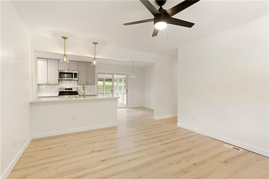 Charming Renovated White Farmhouse in West Forsyth – No HOA! Brand New HVAC! Step into this beautifully renovated white painted brick ranch nestled in the sought-after West Forsyth school district. Ranch home with walk-out backyard. With classic farmhouse charm and modern updates throughout, this home is move-in ready and packed with upgrades. The cedar vaulted front porch welcomes you inside to hardwood floors & fresh paint that flow through every room. Enjoy a brand-new kitchen featuring extended shaker cabinetry, stainless steel appliances, and sleek quartz countertops. The fully renovated bathroom showcases custom tilework and a stylish wood vanity. All three bedrooms are bright and inviting, complemented by new farmhouse trim, upgraded lighting, and new doors throughout. Outside, relax on the screened back porch or entertain in your private, fenced backyard. A large carport, detached garage/storage building with a private drive is the perfect workshop for hobbies, parking, or storage. The crawl space has been professionally wrapped with a new vapor barrier. Perfect blend of country style and modern comfort. Great investment property, first time home or those looking to downsize to one level living!