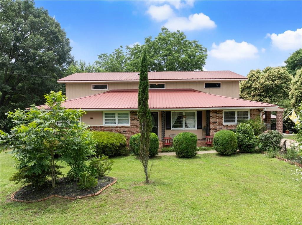 Welcome to 157 Glendale Heights-a rare and spacious find offering 7 bedrooms, 3 full bathrooms, and endless possibilities in a peaceful, convenient location just minutes from Athens. Whether you're looking to accommodate a large family, support multigenerational living, or simply need room to spread out, this one-of-a-kind property has the space and flexibility to meet your needs. Inside, you'll find a well-designed layout with multiple living areas, perfect for relaxing, entertaining, or carving out dedicated spaces for a home office, playroom, or creative studio. The oversized bedrooms provide comfort and privacy for everyone, while the generous square footage offers flexibility to fit your lifestyle. Set on a level, usable 0.7-acre lot, the outdoors is just as impressive. Enjoy a beautifully landscaped yard filled with mature plants and fruit trees-a perfect haven for gardening enthusiasts or those who love spending time in nature. There's plenty of room for outdoor gatherings, pets, or even future additions. The huge 3-bay garage/workshop is a major bonus, offering ample space for vehicles, tools, and storage. It's an ideal setup for hobbyists, tinkerers, or even small business owners needing extra room to operate. With a location that offers peaceful surroundings and quick access to Eastside shopping, dining, and schools, this home truly combines function, comfort, and charm in one incredible package. Don't miss your chance to own this spacious and versatile home-schedule your private tour today! *Receive lender credit when using Casey Simmons, Homeowners Financial Group*