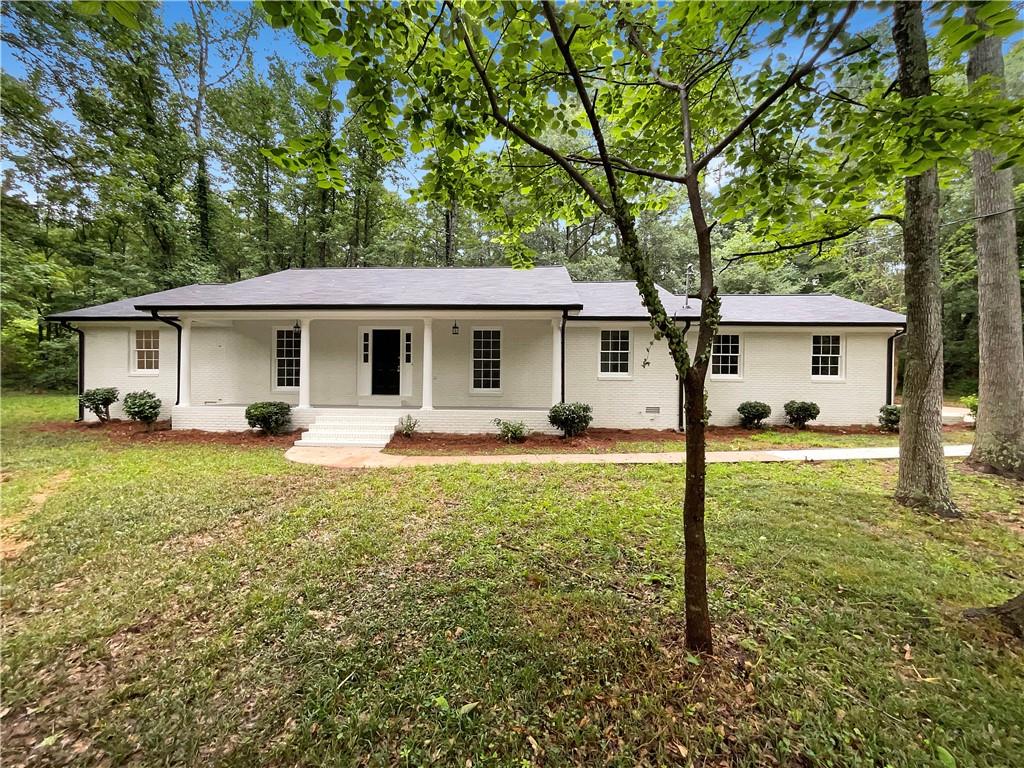 Welcome to 185 Danbury Ct — a beautifully renovated 4-sided brick ranch nestled on a serene cul-de-sac lot just under an acre in the heart of Athens. This 3-bedroom, 2-bathroom home blends timeless charm with thoughtful updates and a location that offers the best of both privacy and convenience.
Step onto the inviting covered front porch, perfect for a morning cup of coffee or evening relaxation, and into a spacious, light-filled interior. The vaulted family room features a cozy fireplace and opens seamlessly to the formal dining room, creating an easy flow for everyday living or entertaining.
The showstopper kitchen has been updated and reimagined with a large center island with built-in cooktop, sleek granite countertops, stainless steel appliances, and white cabinets. Whether you're hosting friends or preparing weeknight meals, this kitchen offers both style and functionality. The primary suite is a peaceful retreat with a walk-in closet and a private bath featuring dual vanities for added convenience. Two additional bedrooms provide flexibility for guests, a home office, or family members, and share a well- appointed full bath. One of the standout features of this home is the spacious sunroom, filled with natural light and overlooking the expansive backyard — a perfect space for relaxing, entertaining, or even a hobby room or second living area. Enjoy recent updates including a new roof, new luxury flooring, fresh interior and exterior paint, and more — offering move-in peace of mind. Outside, the nearly 1-acre level lot provides endless potential for gardening, recreation, or future
expansion. There’s plenty of room to enjoy outdoor living, host gatherings, or simply unwind in your own private retreat. All of this is located just minutes from the University of Georgia, downtown Athens, top-rated schools, shopping, dining, and major roadways — making this home ideal for families, professionals, or those seeking comfort and convenience in a well-established neighborhood.