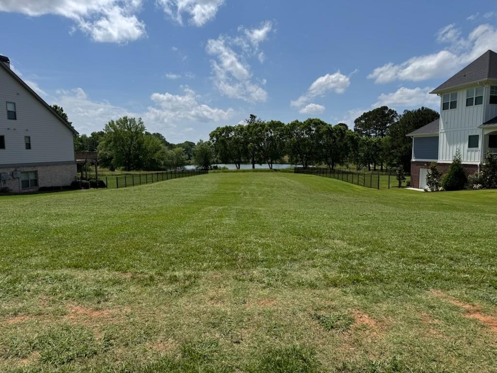 Rare Opportunity to Build Your Dream Home with Golf Course and Lake Views in The Traditions of Braselton – Northeast Georgia’s Premier Community
Discover an exceptional opportunity to own one of the last remaining golf course lots with stunning lake views in the prestigious Traditions of Braselton community, located in highly desirable Jackson County, GA. This remarkable homesite is nestled in the most exclusive section of the neighborhood, offering the perfect canvas for your custom dream home.
Positioned along an immaculately maintained, privately owned 18-hole golf course, this lot combines natural beauty, privacy, and convenience. With a gentle slope from front to back, it's ideally suited for a home with a basement level. The lot has already been cleared and includes custom home and pool plans designed by one of the region’s leading architects and landscape architects—saving you time and ensuring a perfect fit for the land.
Key Features:
Prime Golf Course Lot with panoramic lake views
Located in the Elite Section of Traditions of Braselton
Ready-to-Build – Lot already cleared and prepped
Includes Custom Home & Pool Design Plans
Ideal Topography for a basement-style home
Quick Access to and from the community entrance
Resort-Style Amenities within walking distance:
Junior Olympic Pool with Splash Zone
Tennis & Pickleball Courts
Festival Lawn & Clubhouse
State-of-the-art Gym & Yoga Studio!
This is one of the last opportunities to secure a premium homesite in this sought-after community. Enjoy a tranquil, upscale lifestyle with the perfect blend of recreation, elegance, and natural charm. Whether you're looking to build your forever home or a weekend retreat, this lot offers everything you need to bring your vision to life.
Don’t miss your chance to live in one of Northeast Georgia’s most beautiful and amenity-rich communities.