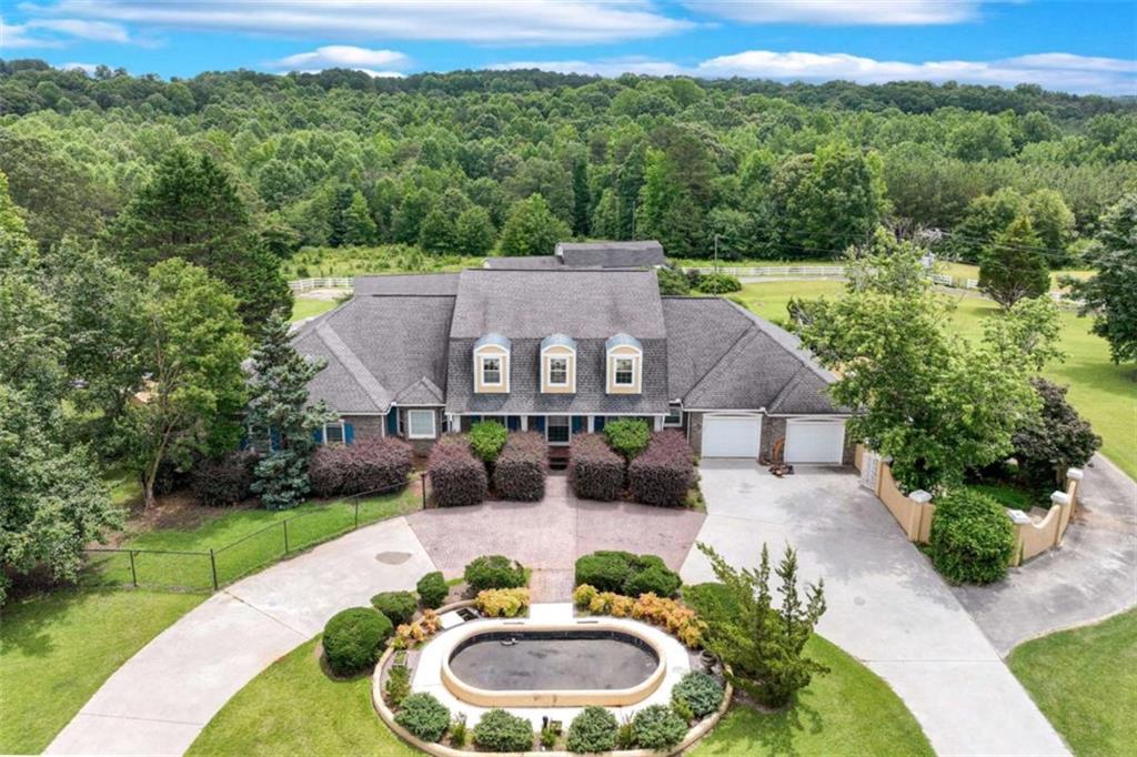 Nestled on 11.92 acres, this estate offers privacy & space just minutes from downtown Toccoa & I-85! The centerpiece of the property is a 5,828 sqft brick home, thoughtfully designed for comfort and elegance. Step inside to find expansive living spaces, high ceilings, an open concept kitchen, dining & living area, multiple fireplaces, and plenty of room for entertaining or relaxing. Upstairs you'll find ample space for storage or bonus rooms. The basement includes a full kitchen, bathroom, living area & extra room for flex space. Outdoors, enjoy an in-ground swimming pool, complete with a pool house-perfect for summer gatherings. Car enthusiasts or hobbyists will love the 2,250 sqft garage, while the impressive 3,220 sqft barn offers endless possibilities for storage or livestock use. The property also features fenced pastureland, ideal for horses or livestock, and a meandering creek that adds to the natural beauty of the setting. Whether you're looking for a private estate, a working mini-farm, or a countryside escape, 701 Sunshine Road has it all! **Currently enrolled in Conservation**