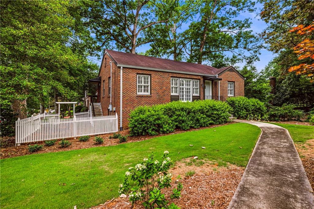 Brick residence featuring multiple window styles