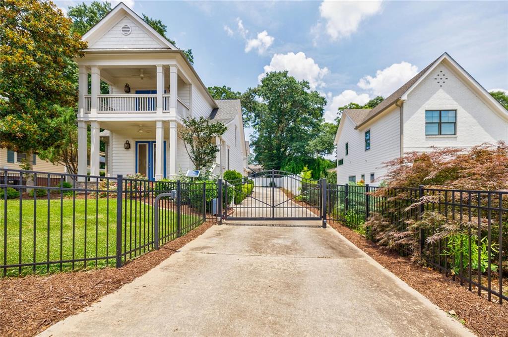 This Custom-built Gated Craftsman style home is located across the street from top-rated Woodward Academy, and a short drive from Downtown Atlanta, Hartsfield Airport, Porche and Tyler Perry Studios. Featuring 4 bedrooms and 4 full baths. One bedroom and a full bath is conveniently located on the Main Level. Open living/dining floorplan. Livingroom has built-in cabinetry and double doors to front porch. Kitchen with granite counter tops, stainless steel appliances, and walk-in Pantry. The Primary bedroom suite has barn door to new updated bath with large glass shower and double doors to balcony. A second bedroom, a full bath and an office/loft space with built-in desk completes the upper level. The Main level also features a walk-out kitchen breezeway with side door to the two-car garage. A large bedroom/ flex room with full bath is above the garage and is perfect as a guest/ teenage suite or Airbnb/ rental space. Additional features are new carpet in bedrooms, new neutral paint throughout, custom closets, 3 HVAC systems, irrigation, private fenced-in backyard and automatic gate. Don't miss your chance to call this charming house your Home!
