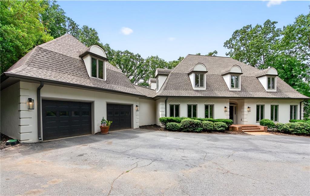 Tucked along one of East Cobb's most admired streets, this newly renovated home offers a rare combination of privacy, views, and location. It looks directly onto a serene lake along the Atlanta Country Club Golf Course 11th Hole, blending beauty with the quiet prestige of country club living. Inside is open, open, open with beautiful views of the great outdoors. Outside, an expansive driveway with ample turnaround space makes hosting gatherings a breeze.
Floor plans are photos 32-35.