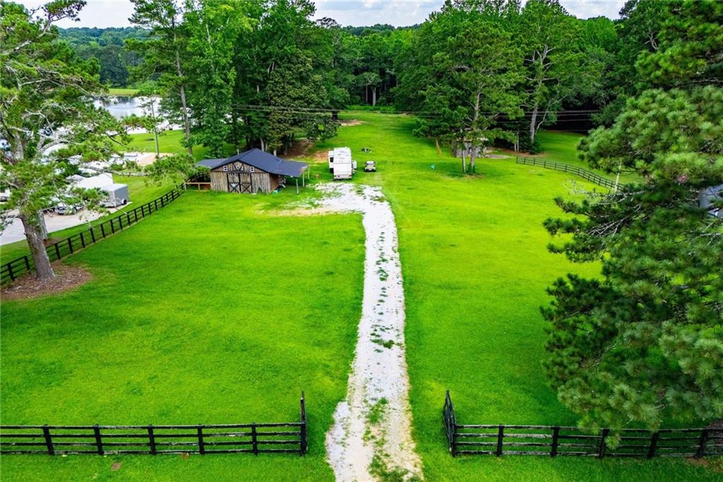 Discover the perfect canvas for your dream home on this 2.1-acre cleared and level lot located in one of Carrollton's most sought-after areas. This beautiful piece of property is build-ready with water and electric already available, perc test completed, and propane gas accessible. Nestled in a peaceful setting, the land features a 26x26 barn with a cozy wood-burning stove, ideal for storage, hobbies, or a rustic workshop. There's also an RV/camper hookup on site for added convenience or temporary living while you build. Enjoy creek access at the back of the property, lake views, and a touch of history with an original 1800s chimney that adds charm and character to the landscape. Whether you're looking to build your forever home, invest in land, or escape to a serene retreat, this property offers a rare combination of location, readiness, and unique features. Don't miss out- come walk the land and experience its beauty for yourself!