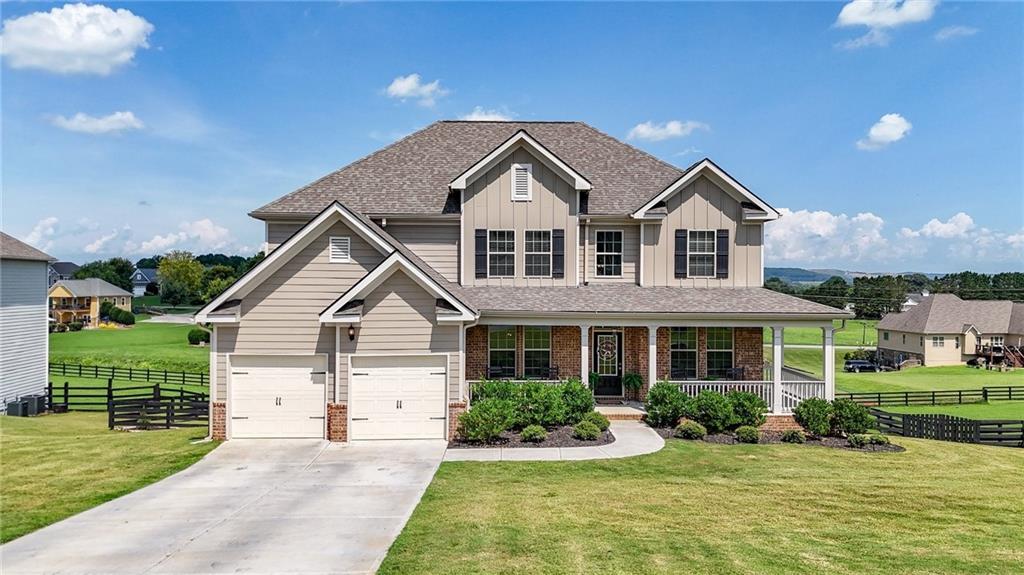 Built in 2023 and meticulously maintained, this like-new residence offers timeless design, refined finishes, and a harmonious blend of elegance and everyday comfort in a scenic mountain view setting.
A grand two-story foyer welcomes you inside, setting the tone for the spacious and thoughtfully designed interior. To the left, a formal dining room with coffered ceilings offers an elegant space for hosting. To the right, a flexible living area adds both style and function, perfect as a home office, sitting room, or play space.
At the heart of the home, the open-concept family room features a beautiful fireplace and flows seamlessly into the casual dining area and gourmet kitchen. Designed for both everyday living and entertaining, the kitchen showcases granite countertops, stainless steel appliances, a breakfast bar, and ample cabinetry and prep space.
A full guest suite is located on the main level, with a well-appointed bathroom that offers dual access, from both the bedroom and the main living area, creating a versatile and private retreat for overnight guests.
Upstairs, the expansive primary suite feels like its own private wing, complete with a separate sitting area, tray ceilings, and two oversized walk-in closets. The en suite bath evokes a spa-like retreat with dual vanities, a deep soaking tub, and a separate glass-enclosed shower. Secondary bedrooms are generous in size, with one enjoying a private bath and two sharing a well-appointed hall bath. A conveniently located upstairs laundry room adds everyday ease.
The home offers ample storage throughout, including walk-in closets, extra linen closets, and an unfinished daylight basement that provides room to grow, already stubbed for a bathroom and ready for your custom finish.
Outdoor living is just as inviting, with a spacious front porch, an elevated back deck ideal for morning coffee or sunset views, and a covered patio that extends from the walk-out basement. A fenced backyard features stone steps, lush landscaping, and a firepit area for cozy evenings under the stars.
Located near neighborhood amenities and just minutes from conveniences, this property offers the perfect blend of luxury, comfort, and thoughtful design, ready to welcome you home.