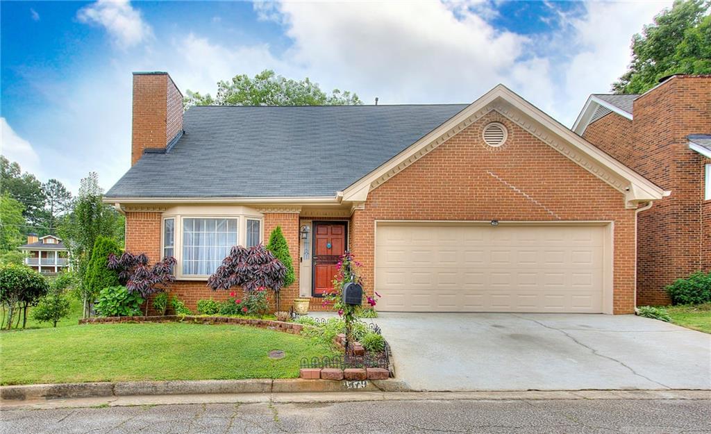 Welcome to this lovely all brick, 4 bedroom 2.5 bathroom home priced under $375K! This charming property boasts several wonderful features, including a primary bedroom located on the main level, all hardwood floors downstairs, and low maintenance laminate flooring upstairs. The airy living room has attractively high ceilings, that make the home seem twice its size. Enjoy your morning coffee in the large eat-in kitchen that has an abundance of storage and counter space, as well as a separate pantry. The exterior is equally as splendid. Nestled on a quiet cul de sac, the home sits on a private, level lot and there is also an attached 2 car garage. The back deck overlooks the well-maintained, fenced backyard. The roof and hot water heater were also recently replaced. Conveniently located in fast-growing Stone Mountain, GA, this property is a jewel. Schedule your exclusive showing today!