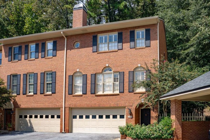 Tucked away in the heart of Vinings, this rare end-unit townhome offers the perfect blend of charm, convenience, and privacy all just a short stroll from the boutiques and restaurants of Vinings Jubilee. One of the largest floorplans in the community, this all-brick home lives spaciously with warm hardwood floors throughout, elegant plantation shutters, and a fireside great room that flows effortlessly into the dining area for easy entertaining. The gourmet kitchen shines with high-end stainless appliances, granite counters, and a sunny breakfast nook with French doors that open to a private stone courtyard a rare and serene outdoor retreat perfect for morning coffee or evening cocktails. Upstairs, the owner's suite feels like a spa escape with dual vanities, a soaking tub, and a walk-in shower, while two additional bedrooms offer versatility for guests, a home office, or creative space. Thoughtful updates like a new HVAC system add comfort and peace of mind, and the two-car garage and community pool complete the picture of easy, elegant living. With its unbeatable location near The Battery, I-75, I-285, and the Chattahoochee River trails, this home captures the best of Vinings walkable, timeless, and effortlessly livable.