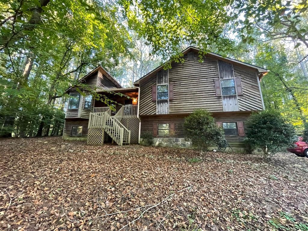 Investor special in Holly Creek Estates! This 3BR/3BA, 2000+ sqft rustic cabin-style home sits on over 1 acre of wooded privacy with tons of potential. Great bones and layout—ready for your renovation vision. Peaceful setting just minutes from downtown Woodstock, Lake Allatoona, shopping & I-575. Cash only, sold as-is. Perfect flip or long-term investment opportunity in a sought-after neighborhood. Act fast don’t miss this rare opportunity!