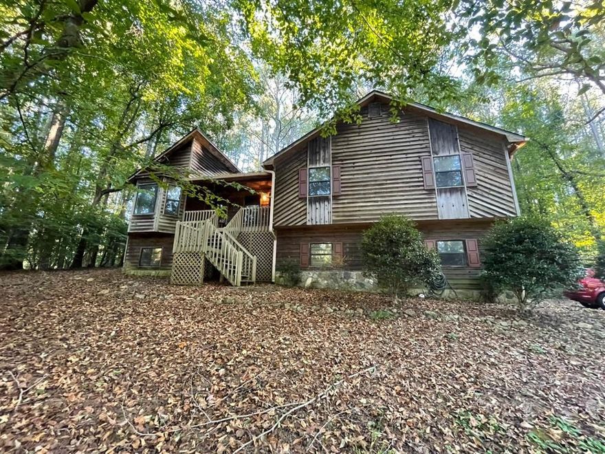 Investor special in Holly Creek Estates! This 3BR/3BA, 2000+ sqft rustic cabin-style home sits on over 1 acre of wooded privacy with tons of potential. Great bones and layout—ready for your renovation vision. Peaceful setting just minutes from downtown Woodstock, Lake Allatoona, shopping & I-575. Cash only, sold as-is. Perfect flip or long-term investment opportunity in a sought-after neighborhood. Act fast don’t miss this rare opportunity!