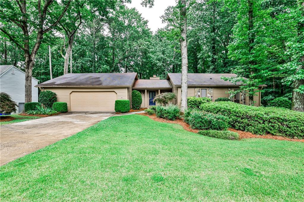Amazing opportunity in Chimney Springs, one of East Cobb’s most sought-after communities! This large ranch-style home is situated in the heart of the neighborhood on a private lot adjacent to the bike and walking path which leads to Chimney Lake and neighborhood amenities. Ready for you to immediately make it your own, or live in as-is and personalize over time! Walking in the front door, you are greeted with beautiful hardwood floors overlooking an expansive living room with vaulted ceiling and stone fireplace as the centerpiece, an adjacent wet bar, and dual sliding glass doors leading to the back deck. The separate dining room connects to the living room for seamless entertaining and features board and batten and a modern light fixture. The spacious eat-in kitchen and breakfast area with updated light fixtures and beadboard wainscoting provide views of the private backyard through sliding glass doors, allowing access to the oversized deck, perfect for relaxing with your morning cup of coffee or grilling in the evenings while entertaining friends! Laundry room with sink connects the garage to the kitchen, creating an ideal drop spot and mud room. The primary suite has a vaulted ceiling with wood beam accent, two spacious closets and ensuite bathroom with recently updated shower. Two additional bedrooms and additional full bathroom complete the main level. The terrace level basement has two large finished rooms ideal for a workout space, home office or playroom and two additional unfinished rooms for storage or an opportunity for you to finish as your own. This is an as-is sale; interior painted 2025, exterior painted Sept 2021, newer HVAC system and newer water heater. Chimney Springs is a very social and amenity-rich neighborhood. Take the trail adjacent to the home and enjoy the swimming pool, clubhouse, tennis and pickle ball courts, lake with bike and walking path, playgrounds, basketball court and activity field. Zoned for top-rated Pope High School, Hightower Trail Middle and Tritt Elementary. This Chimney Springs home is situated within minutes from Avenue East Cobb, Downtown Roswell and offers unmatched convenience in the heart of East Cobb. Welcome Home!