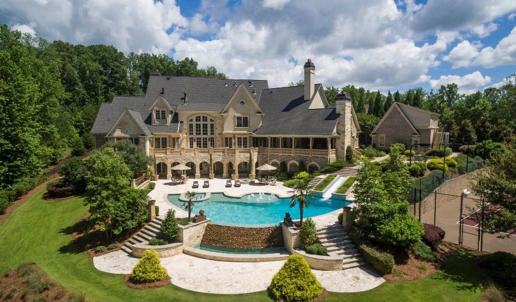FOR the connoisseurs of life that delight in family, friends, the great outdoors, tennis, a good movie, & long summer nights by the pool..THIS is your retreat-surrounded by water! Lighted, reg. size tennis court, lodge-style pool w/slide & spa, screening room, exercise room w/sauna & steam shower, wine cellar, walk-in bar, Guest Apt, 7 garages, hand-hewn floors,elevator & STUNNING kitchen all nestled on +/-3.42 private acres on private lake. EXCEPTIONAL grounds & EXTRAORDINARY craftsmanship. Priced below appraisal. Proof of funds & lender letter req'd for showing.