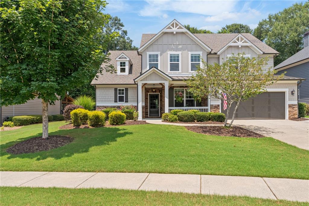 Welcome to this immaculately maintained, move-in ready Craftsman-style home in the sought-after community of Woodstock Knoll. Perfectly located within walking distance or golf cart ride to Downtown Woodstock, this beautiful residence combines timeless architecture, modern comforts, and unmatched convenience. Backing up to protected Corps of Engineers land, the home offers added privacy with no neighbors behind you—ideal for relaxing on the covered back porch or enjoying the fire pit and paver patio! The heart of the home is the open-concept kitchen & living area, designed for entertaining and everyday comfort. The gourmet kitchen features a large center island perfect for gathering + stainless steel appliances + ample cabinet space + walk-in pantry with custom shelving, all overlooking a soaring two-story family room complete with custom built-ins and a stunning double-sided stone fireplace. Offering views of the dreamy backyard, the bright sunroom with vaulted ceiling provides a cozy retreat filled with natural light, ideal for year-round enjoyment! Light, bright, and thoughtfully designed, the home also includes a huge master suite on the main level with double-trey ceiling and backyard views. This oversized primary bedroom includes a spacious bathroom with dual vanities, a soaking tub, and a walk-in shower, along with a generous walk-in closet with custom shelving. Upstairs, three additional bedrooms—each with their own walk-in closets—surround a large open loft, offering the perfect space for a media room, play area, or home office. The home’s thoughtful layout even continues into the garage, which includes an additional 16x10 storage area large enough to accommodate a third vehicle, workshop, or hobby space + new custom cabinetry for even more storage options. Recently painted inside and outside, the systems and mechanicals have all been either recently updated or have been meticulously cared for, making this home truly move-in ready. Living in Woodstock Knoll means more than just a beautiful home—it’s a lifestyle. Residents enjoy access to community amenities including a clubhouse, pool+water slide, and tennis courts, while the charm of Downtown Woodstock is just a short walk or bike ride away. Explore local restaurants like Vingenzo’s and or Century House; grab a drink & BBQ at Reformation Brewery; or catch a concert at the Northside Hospital Amphitheater. With nearby parks, trails, top-rated Cherokee County schools, and easy access to Costco, the Woodstock Outlet Shoppes, and I-575, this location offers the perfect blend of small-town charm and modern convenience. Schedule your private showing today and discover why so many are falling in love with life in Woodstock Knoll.