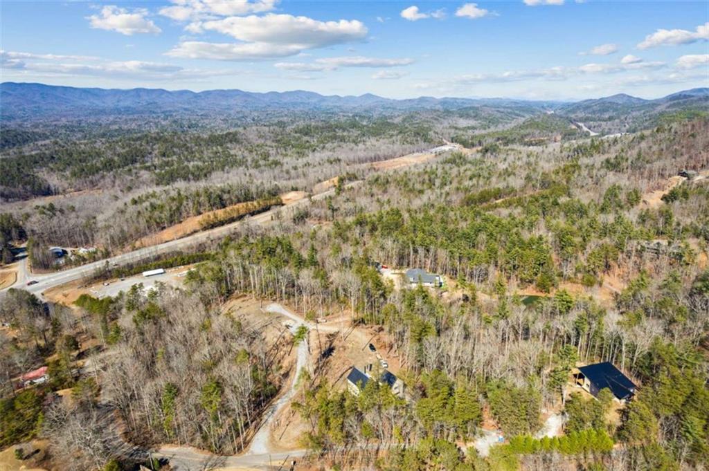 Build your dream home on this perfectly situated 1.82 Acre Lot, nestled in the heart of the North Georgia Mountains! This nearly 2 Acre property offers the ideal blend of privacy, convenience, & natural beauty, making it the perfect spot for your mountain retreat. Location, Location, Location ~ With easy access to both Ellijay & Blue Ridge & a short distance to one of North Georgia's newest fine dining restaurants, The Falls of Blue Ridge, this property offers luxury and convenience for both full-time & part-time living! Step into the mountain lifestyle you've been dreaming of! Whether you're looking for a primary residence, a vacation getaway, or an investment property, this lot puts you right where you want to be. Explore endless hiking trails & waterfalls, cast a line in nearby rivers & lakes, or visit one of the local wineries & orchards ~ all of this at your fingertips! Don't miss your chance to own this exceptional piece of North Georgia! The time is now to secure your place in the mountains - your dream home begins here!