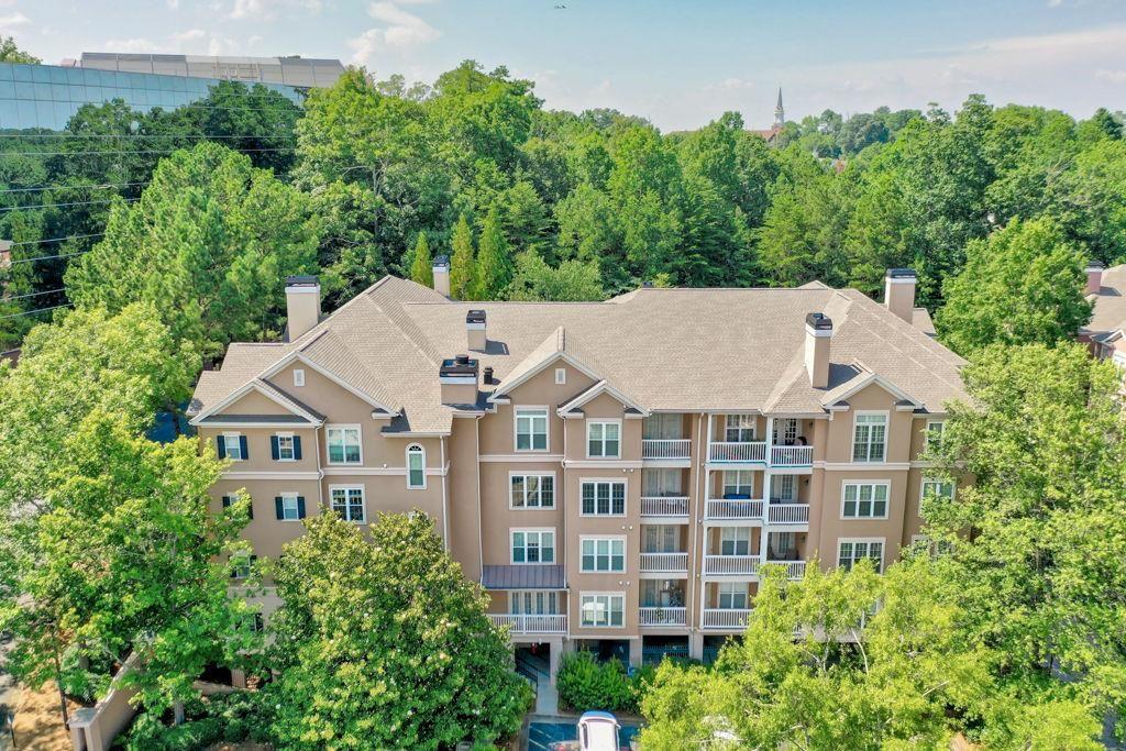 Maintenance-free lifestyle meets unparalleled convenience in the heart of Dunwoody! This gated, lushly landscaped community offers resort-style amenities including a sparkling saltwater pool and a well-equipped fitness center, inviting you to relax into your best life. The fireside living room adjoins the dining area, creating an open, inviting space for relaxation or entertaining. Beyond, a private balcony awaits, perfect for your morning coffee or evening unwind. The chef's kitchen includes stainless steel appliances, a convenient pantry, and abundant counter space, alongside a breakfast room. Both bedrooms are generously sized and filled with natural light, featuring spacious closets for all your storage needs. Enjoy ultimate accessibility with proximity to UPS and Mercedes-Benz, Dunwoody Village, Perimeter Center, the iconic King and Queen Buildings at Concourse, Dunwoody Nature Center, Spruill Center for the Arts, and effortless access to I-285 and GA400. You'll have one covered parking space and ample visitor parking. Just say WOW!